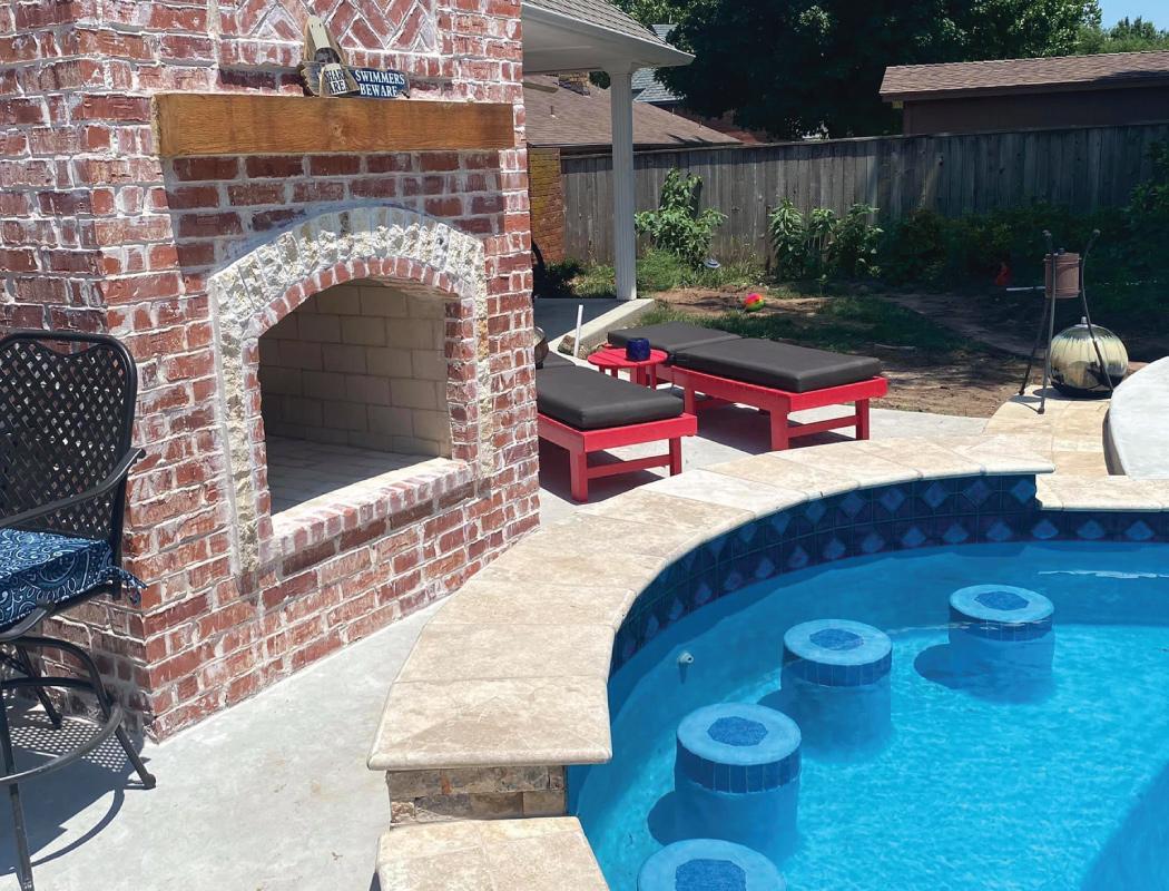custom fireplace an pool with in-water seating and bar area